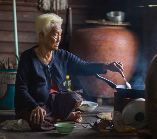 Eldery asian woman cooking