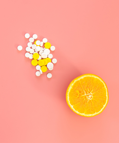 Vitamin c tablets and orange