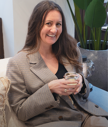 Woman in the checkered blazer is smiling