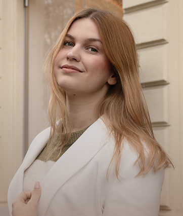 Woman in the white blazer is smiling