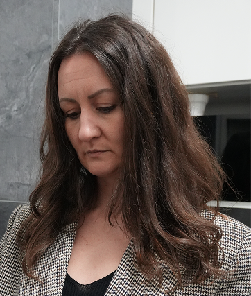 Woman in the checkered blazer is sad