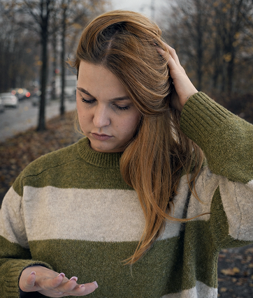 Woman in the green striped sweater is sad